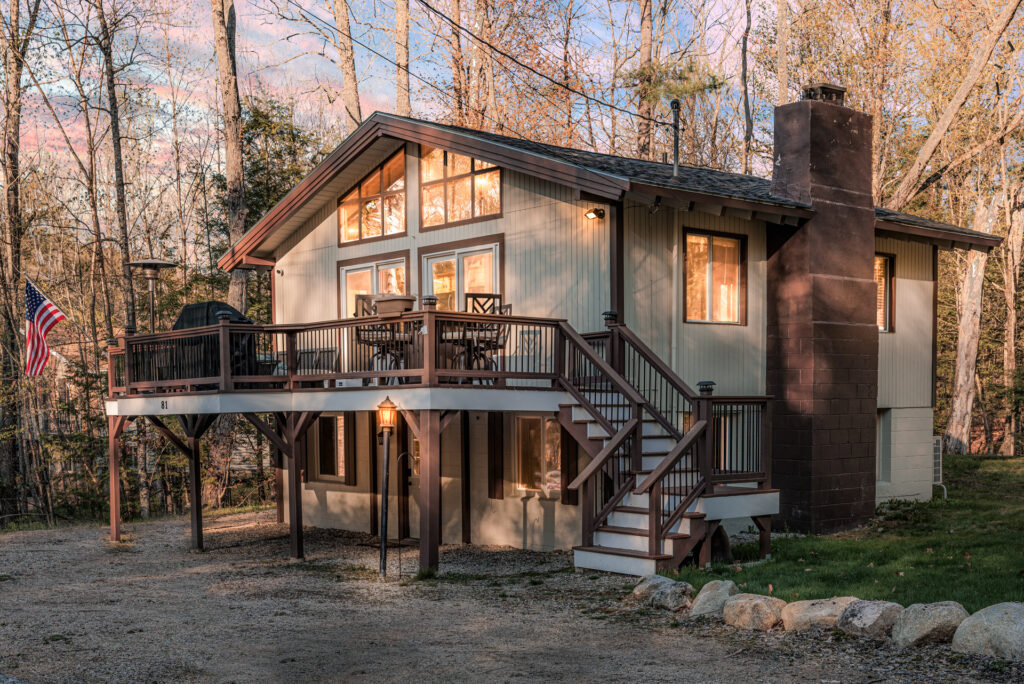 Dramatic exterior image of a swiss chalet style home, shot during twilight hour. The image is one out of many for the purpose of renting it out to potential vacationers.